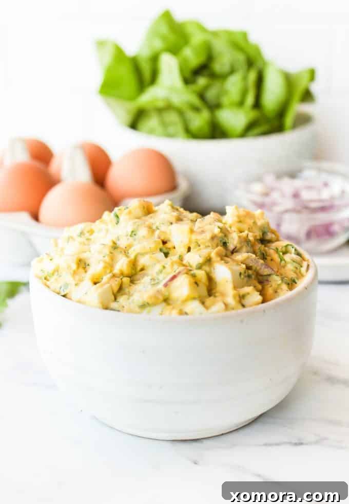 Aromatic Herb Egg Salad 5 Herby Egg Salad on a fork, showing its creamy texture and herb flecks