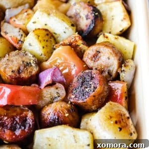 Finished sheet pan sausage, apples, and potatoes, a hearty and colorful meal.