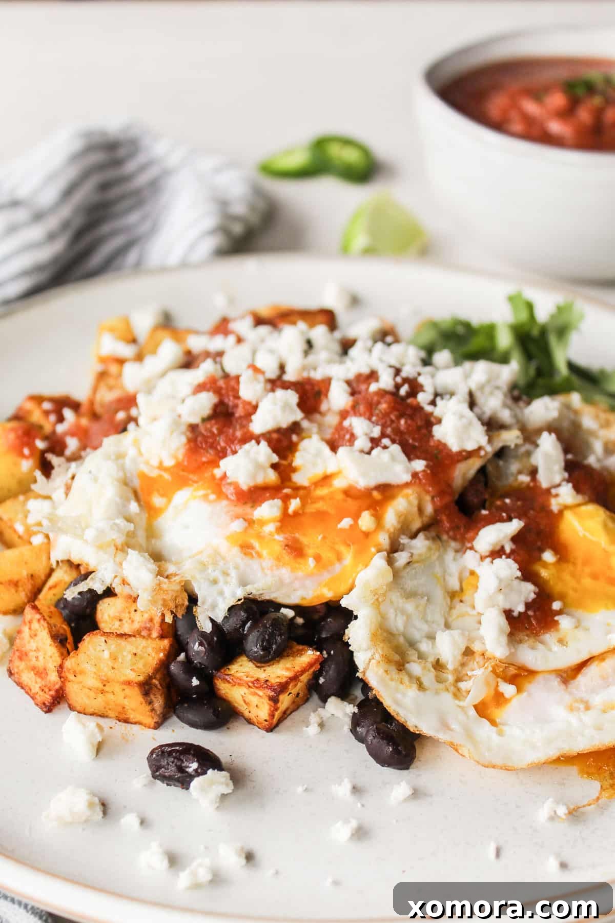 Prepared Air Fryer Potato Huevos Rancheros with a runny egg yolk