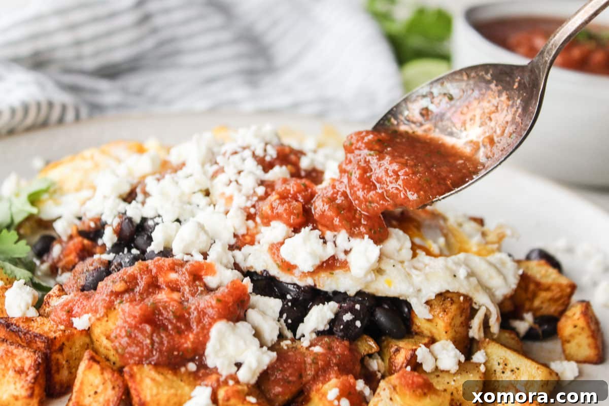A serving of Air Fryer Potato Huevos Rancheros with egg