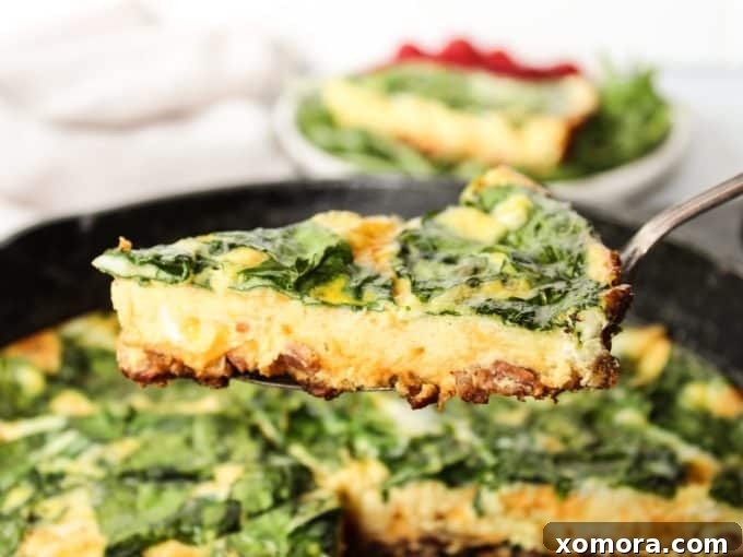 A freshly baked Bacon Spinach Frittata, golden brown and puffed, cooling in a cast iron skillet, ready to be cut into slices.