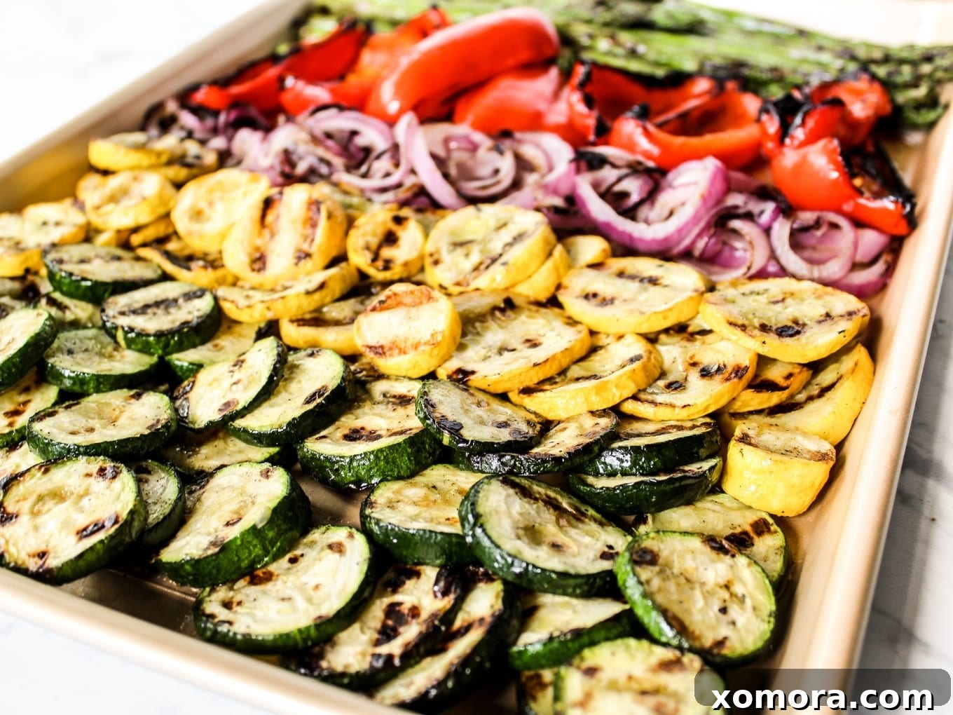 Smoky Grilled Harvest 4 Grilled vegetables fresh off the grill, served on a plate with fresh lemon wedges and herbs.