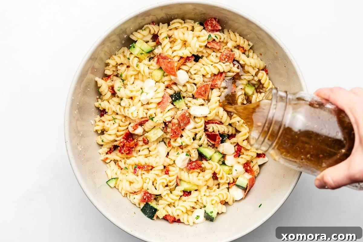 Effortless Italian Pasta Salad 4 Make Ahead Italian Pasta Salad with dressing poured over ingredients