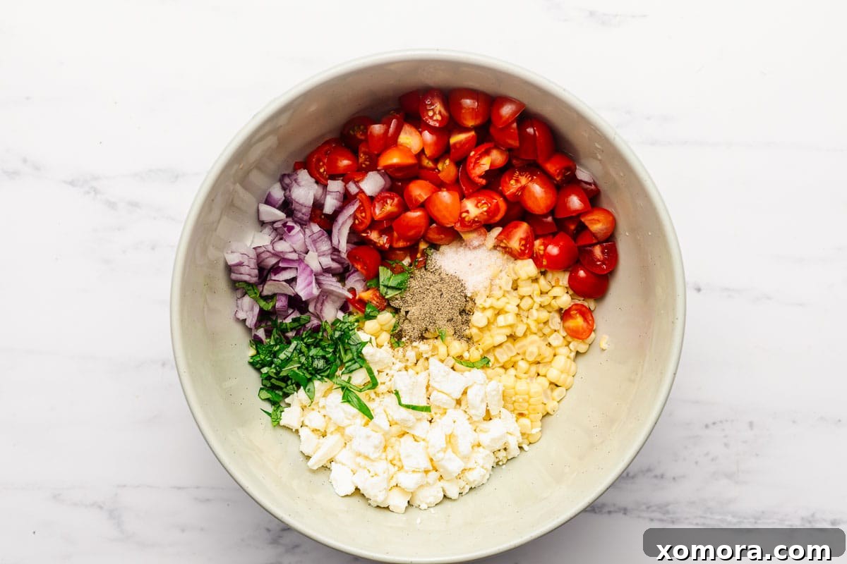 Zesty Charred Corn Salad 4 Ingredients for grilled corn salad laid out on a cutting board.