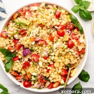 Close-up of grilled corn salad in a white bowl.