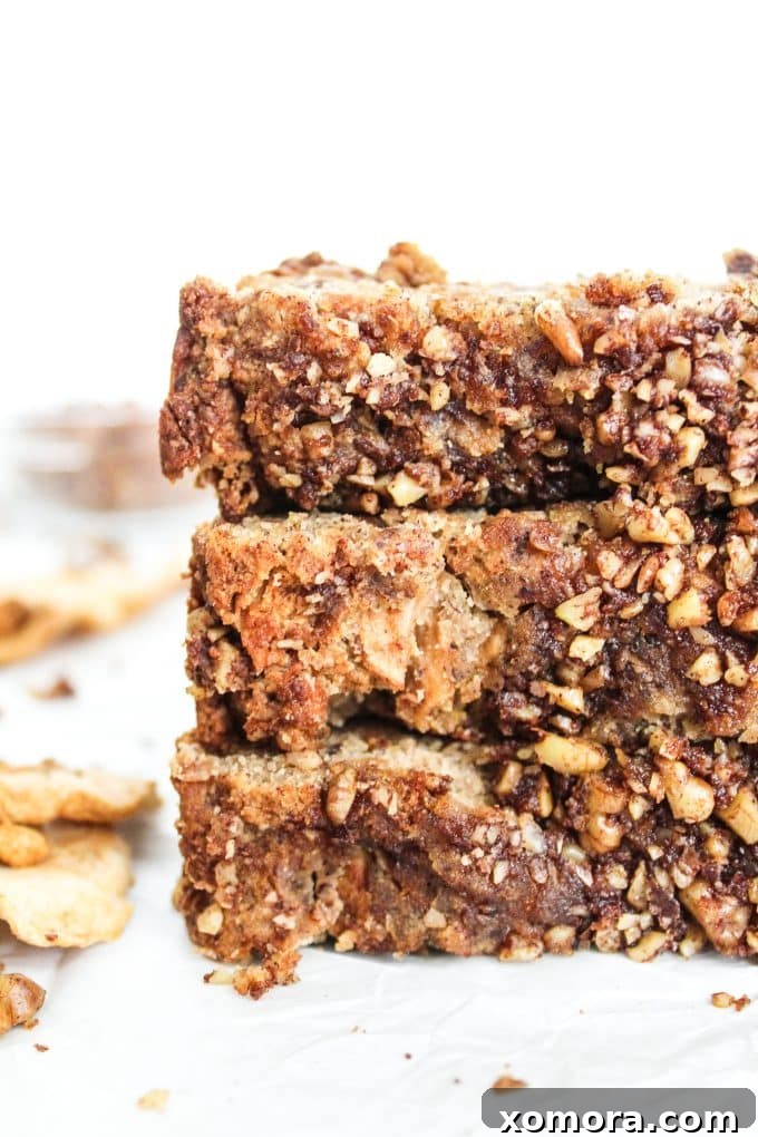Rustic Gluten-Free Apple Walnut Streusel Bread 2 Moist slice of Gluten-Free Apple Bread with Walnut Crumble, showing the cake-like texture and pieces of dried apple