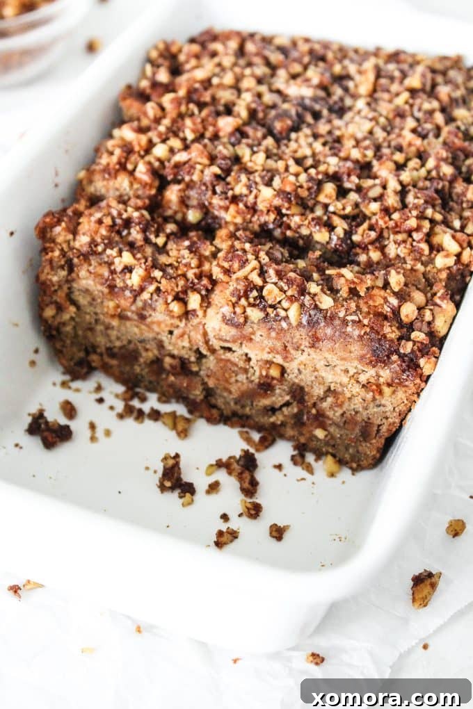 Rustic Gluten-Free Apple Walnut Streusel Bread 6 A freshly baked Gluten-Free Apple Bread loaf with crumble topping, cooling on a wire rack