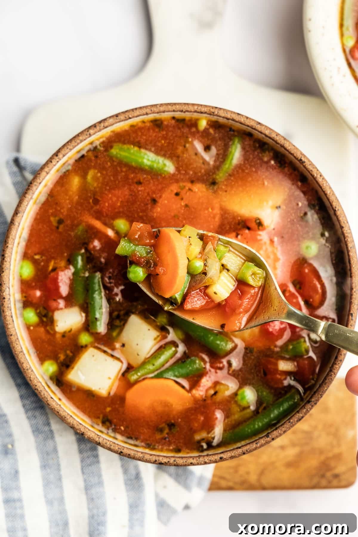 Effortless 30-Minute Vegetable Soup 2 A steaming bowl of hearty vegetable soup, garnished with fresh herbs, ready to be enjoyed on a cozy evening.