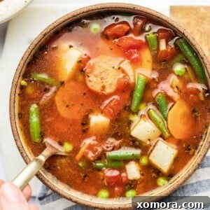 A hearty bowl of 30-Minute Vegetable Soup, garnished with fresh herbs.