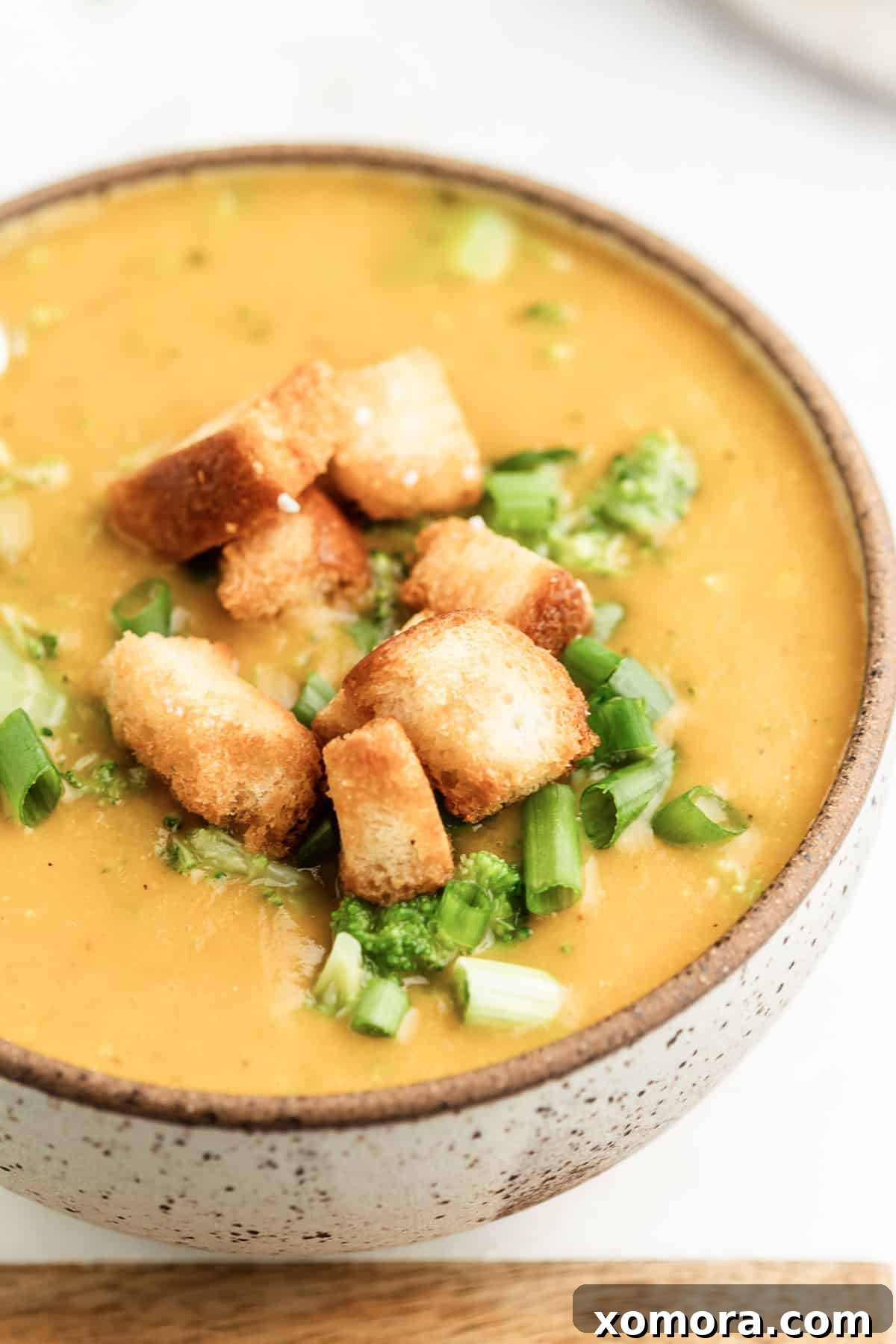 Creamy Dairy Free Broccoli Cheddar Soup 4 A serving of dairy-free broccoli cheese soup in a ceramic bowl, ready to be enjoyed.