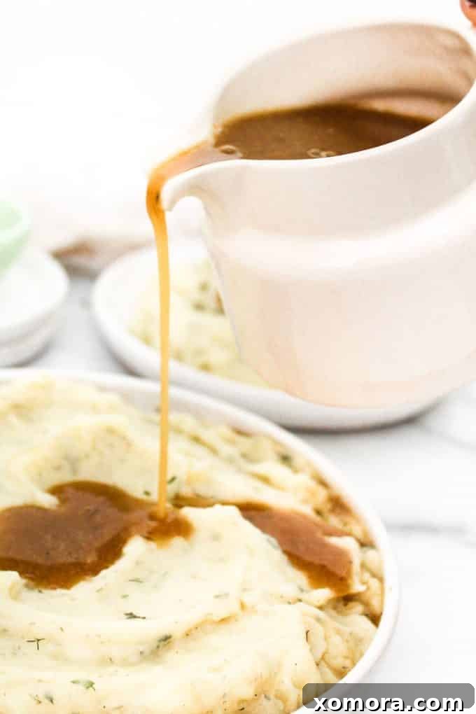 Close-up shot of the velvety smooth texture of the vegan gravy in a white ceramic gravy boat.