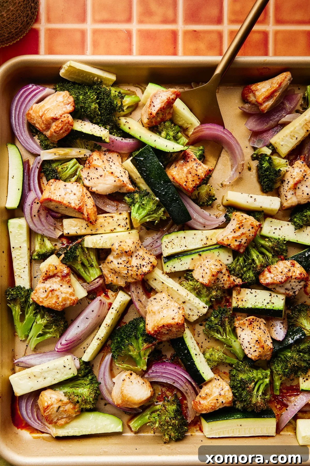 Sheet Pan Roasted Chicken and Seasonal Vegetables 5 Serving suggestion for easy baked chicken and vegetables, placed over white rice with a sprinkle of fresh herbs.
