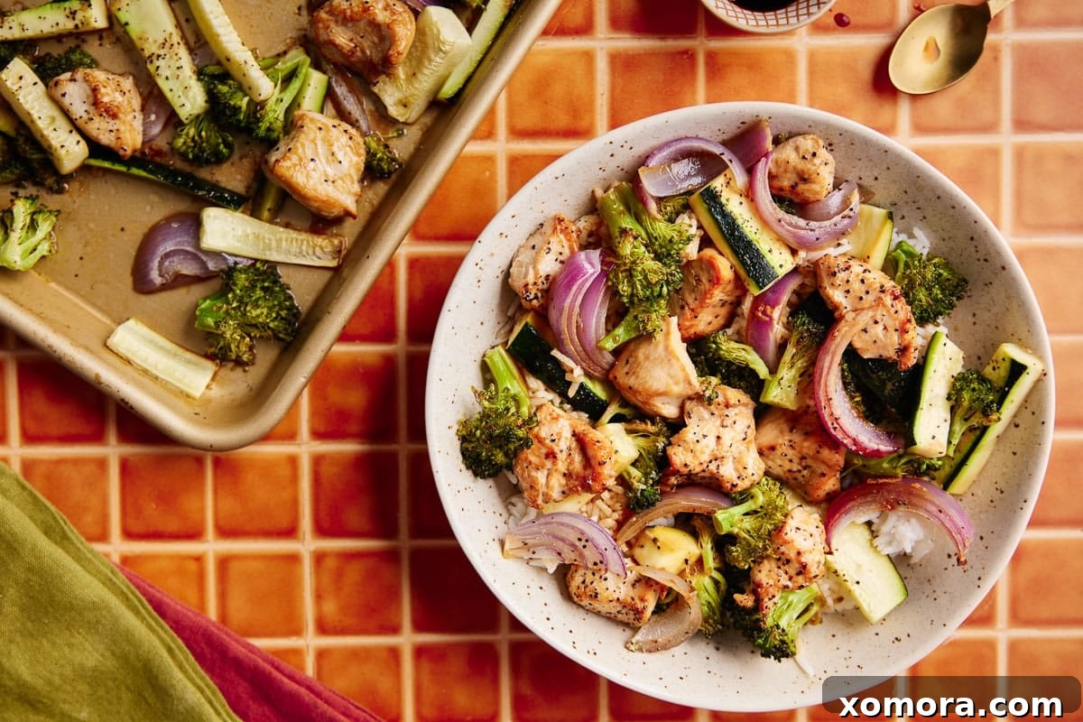 Sheet Pan Roasted Chicken and Seasonal Vegetables 6 A serving of the easy baked chicken and vegetables on a plate, ready to be enjoyed.