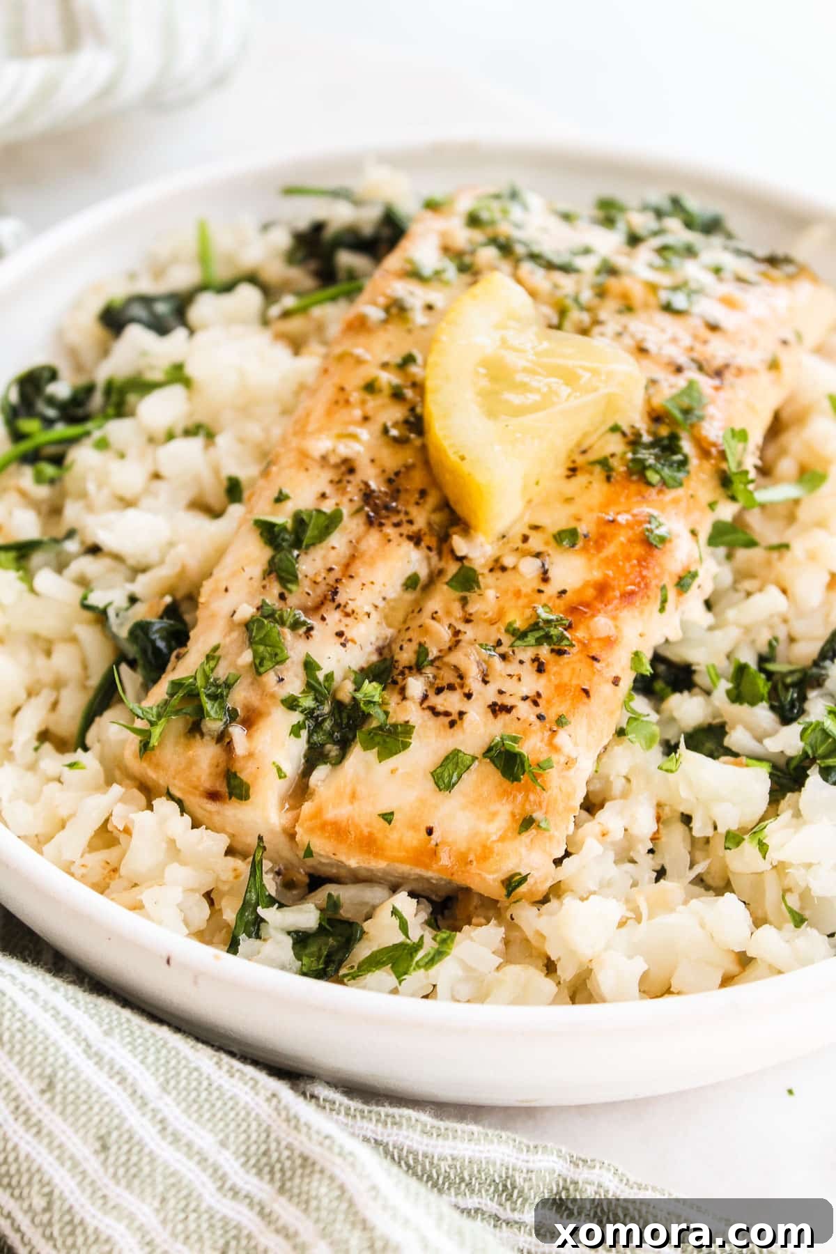 up close shot of mahi mahi on cauliflower rice in a bowl