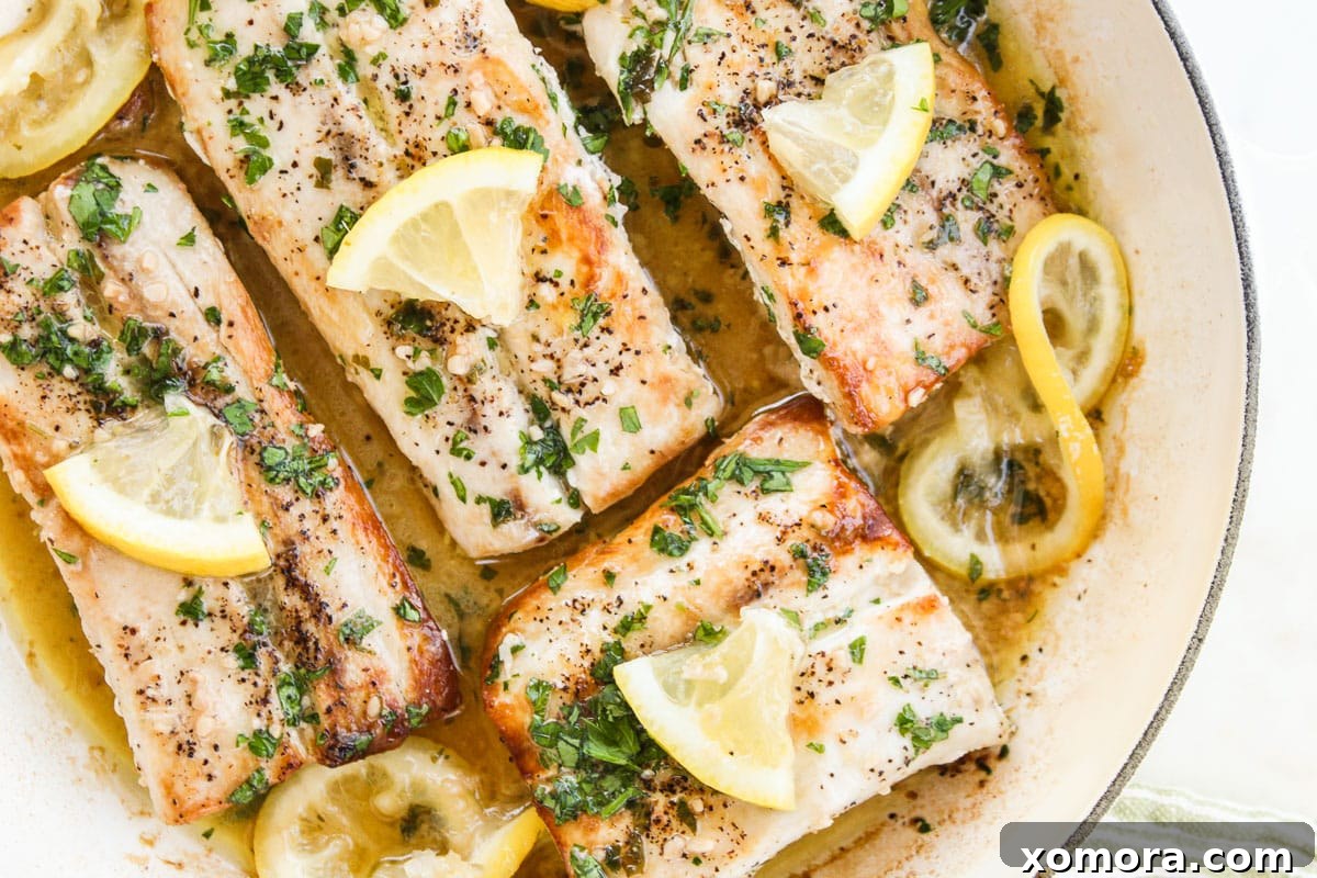 up close shot of mahi mahi in lemon butter sauce in a skillet