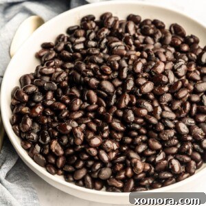 A bowl of freshly cooked Instant Pot Black Beans, garnished with cilantro.