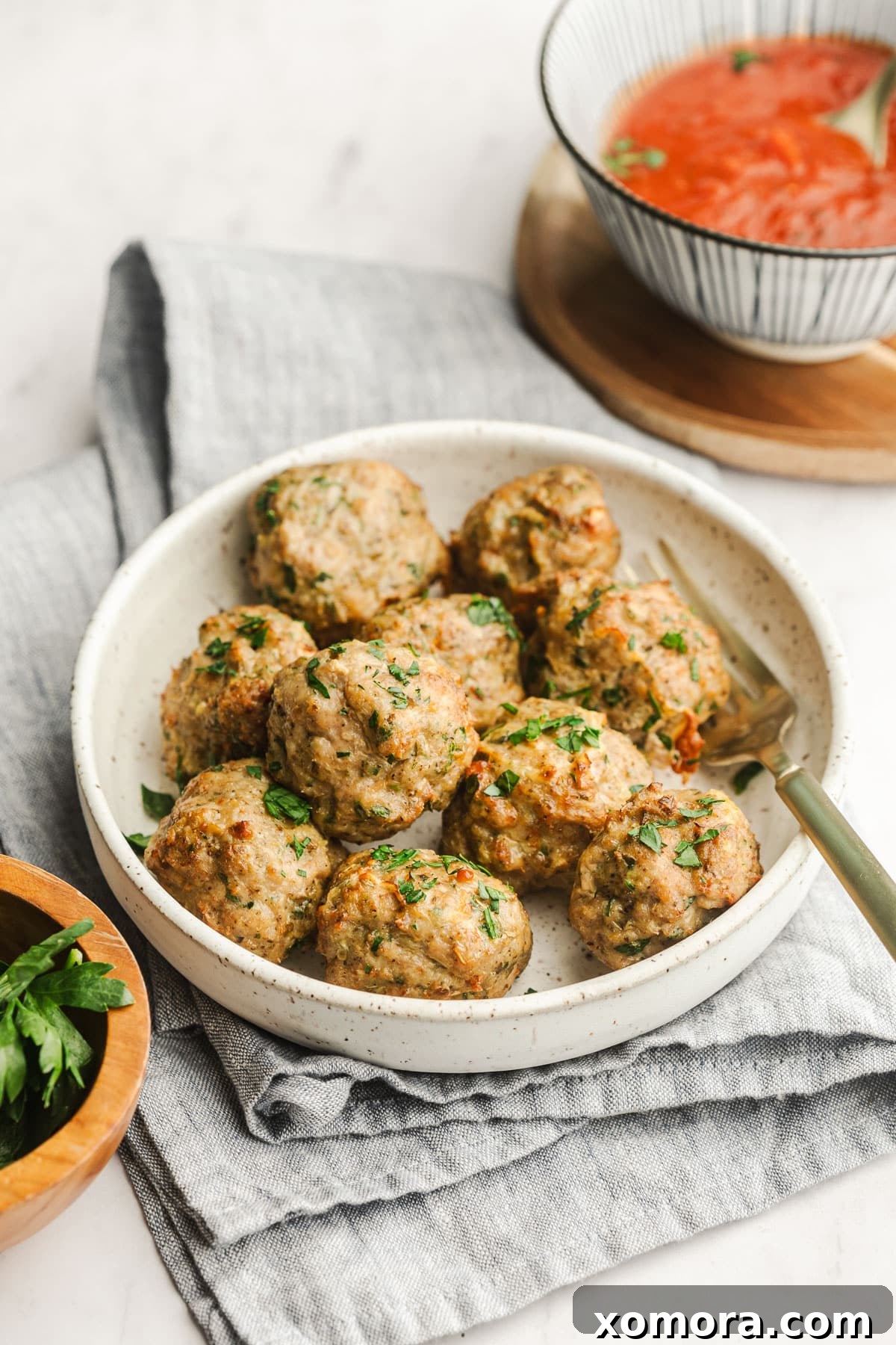 A serving of air fryer turkey meatballs garnished with fresh parsley.