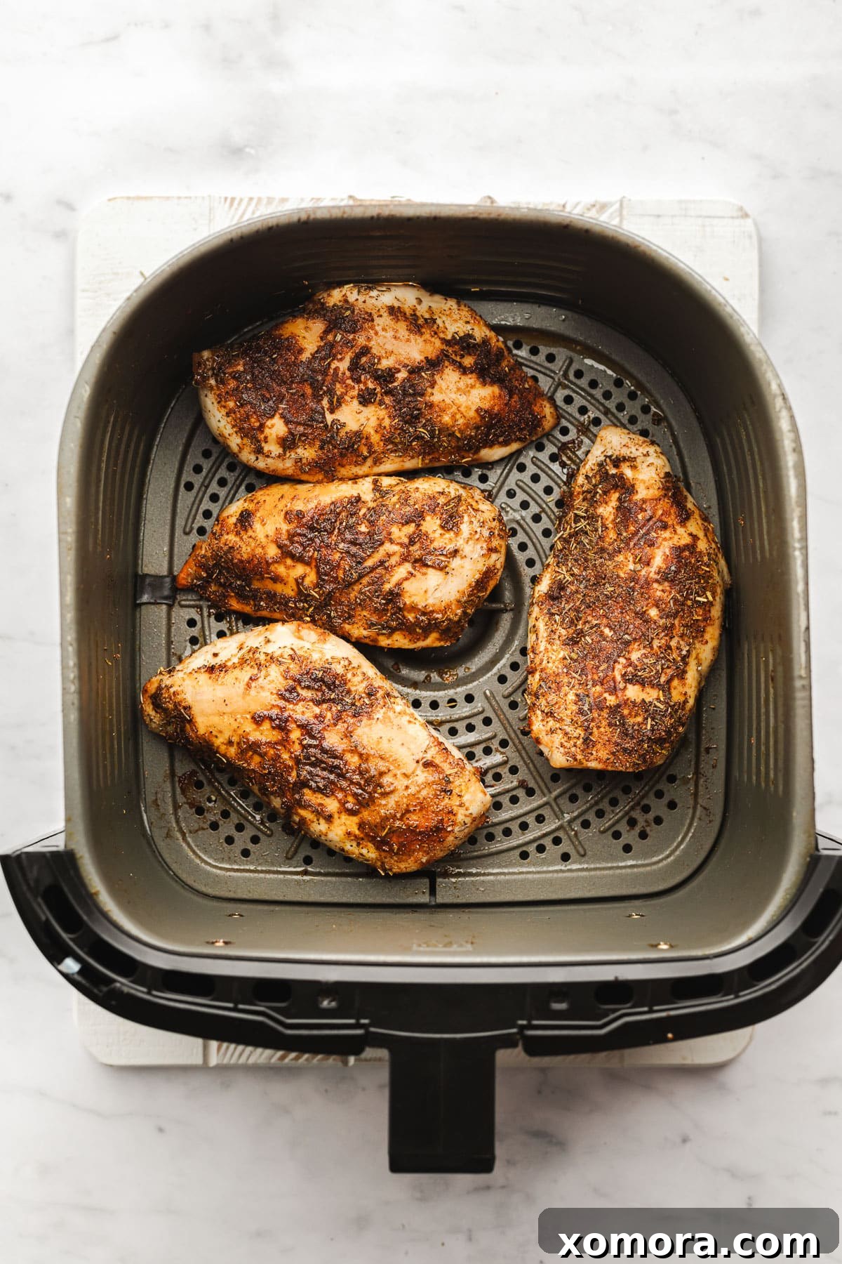 Juicy Air Fryer Chicken Breasts 3 Seasoned chicken breasts ready for the air fryer