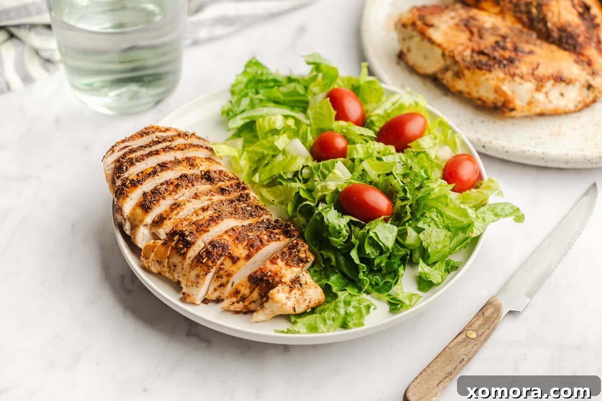 Juicy Air Fryer Chicken Breasts 4 Air fried chicken breasts served on a cutting board