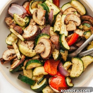 Crispy Air Fryer Vegetable Perfection 7 Air-fried zucchini, bell peppers, onions, and mushrooms arranged on a plate.