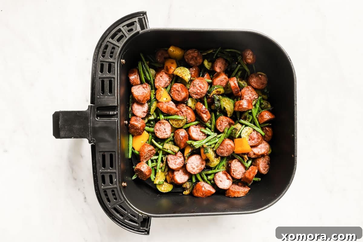 Crispy Air Fryer Sausage and Roasted Vegetables 5 Baked sausage and vegetables on a parchment-lined baking sheet