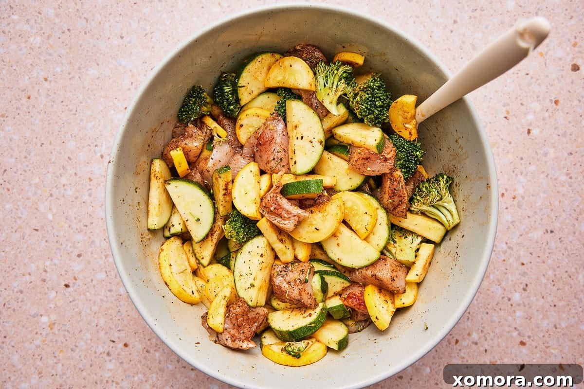 Air Fryer Chicken and Vegetables cooking in an air fryer basket
