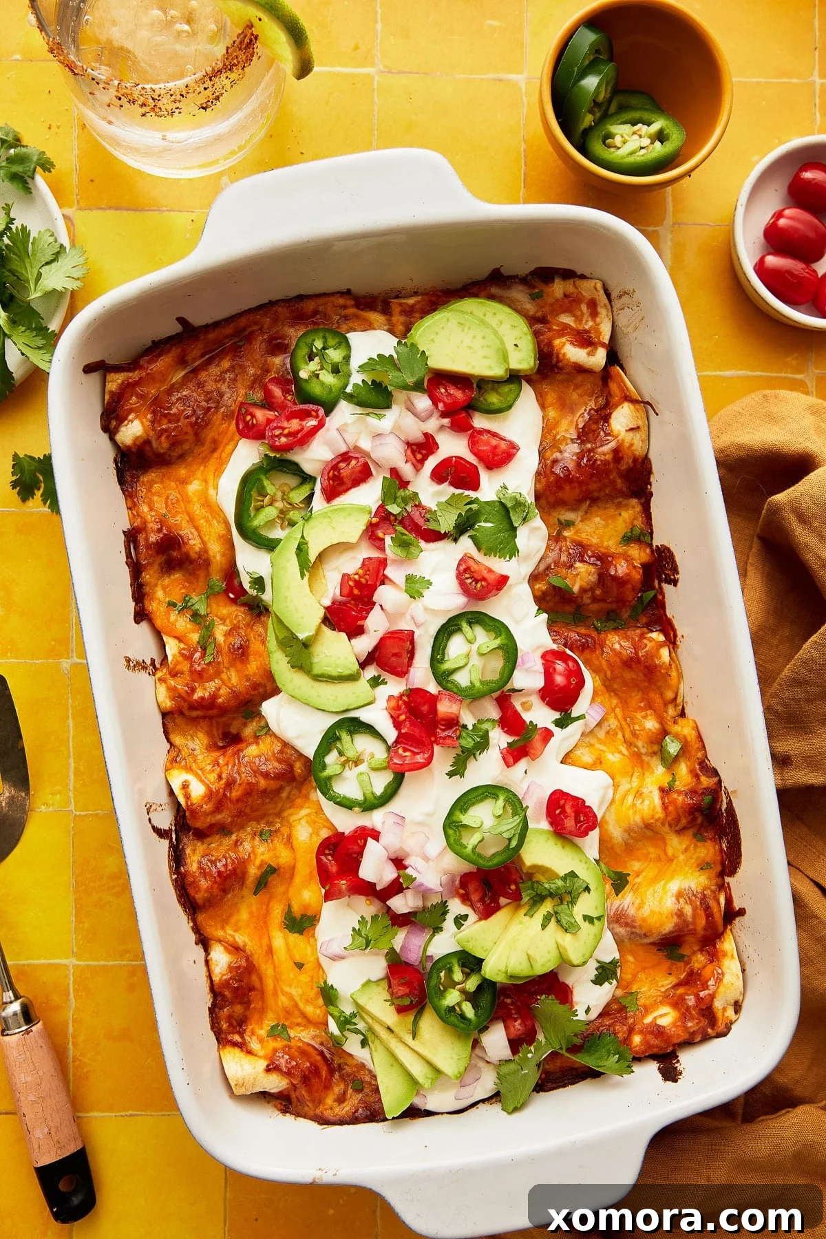 Effortless Cheesy Chicken Enchiladas 6 Close-up of baked chicken enchiladas, showing the melted cheese and a bit of sauce.