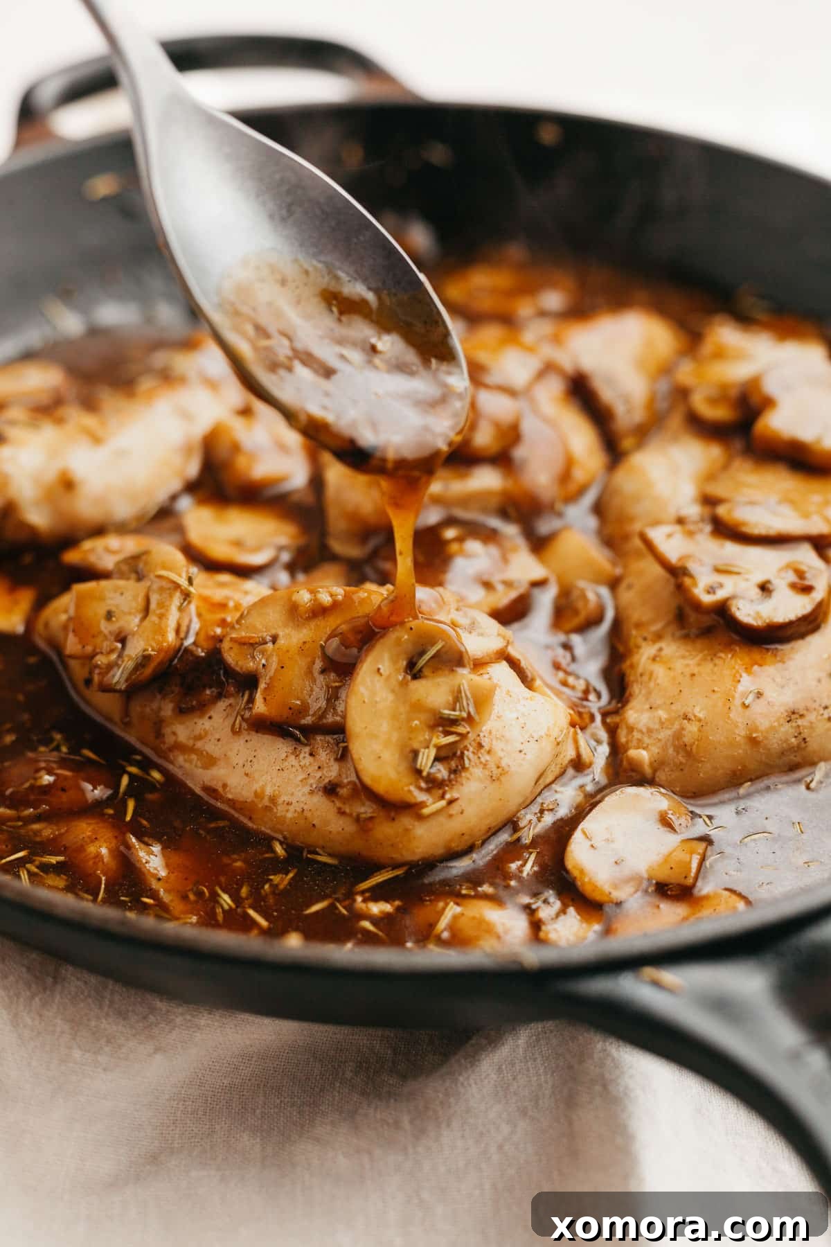 Guilt-Free Chicken Marsala 5 Healthy Chicken Marsala garnished with fresh herbs, showcasing its rich, thick sauce.