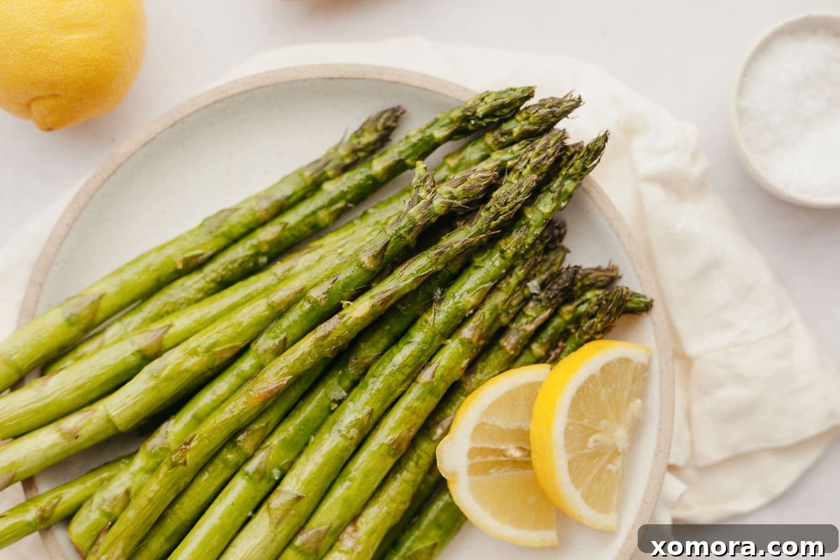 A basket full of air-fried asparagus, perfectly cooked and golden brown.