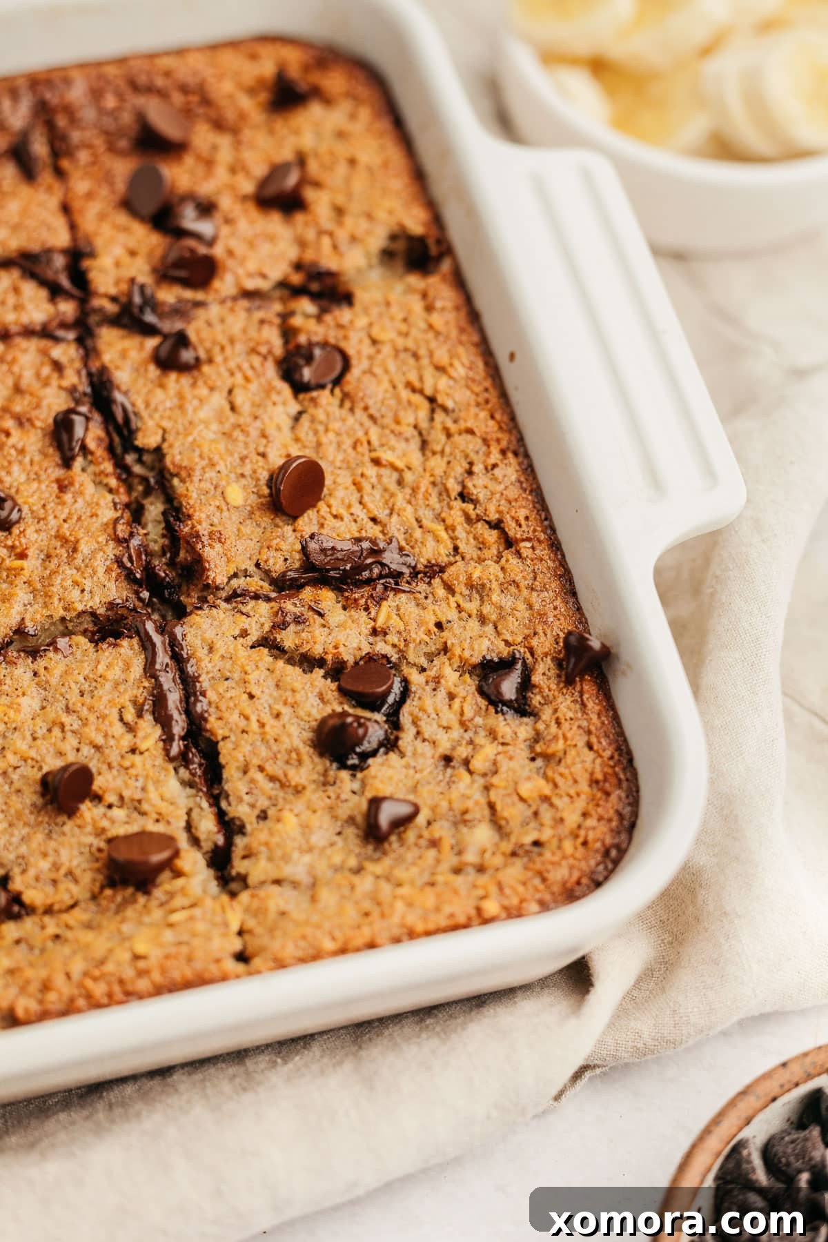 Warm Banana Chocolate Chip Baked Oats 5 A slice of baked banana chocolate chip oatmeal on a plate