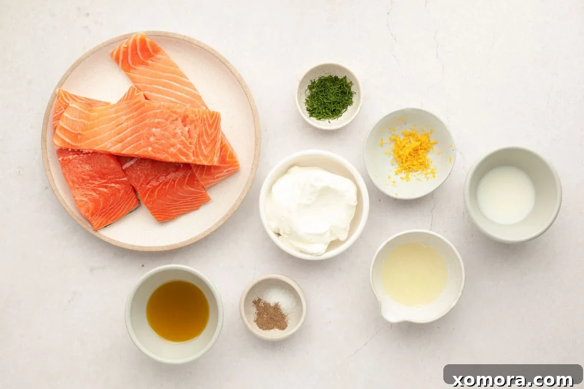 Deliciously Simple Lemon Dill Oven Salmon 3 Close-up of creamy lemon dill sauce in a bowl, with fresh dill garnishes.