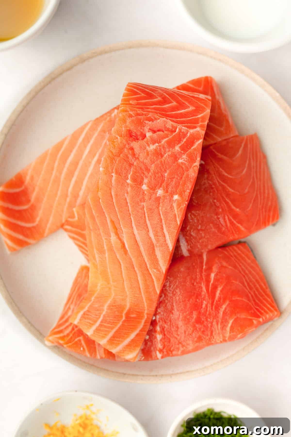 Deliciously Simple Lemon Dill Oven Salmon 4 Ingredients laid out for making lemon dill sauce: yogurt, mayo, lemon, dill.
