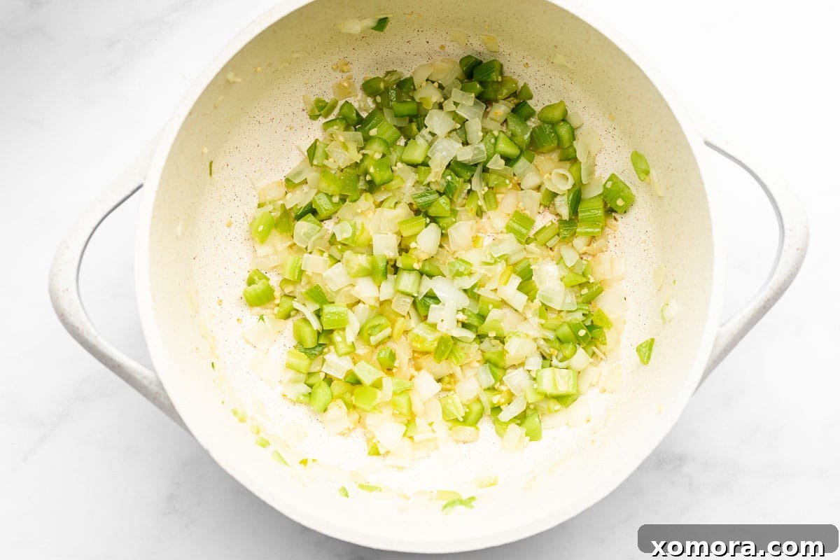 Close-up of hearty chicken and vegetable soup in a pot, showcasing the vibrant ingredients.