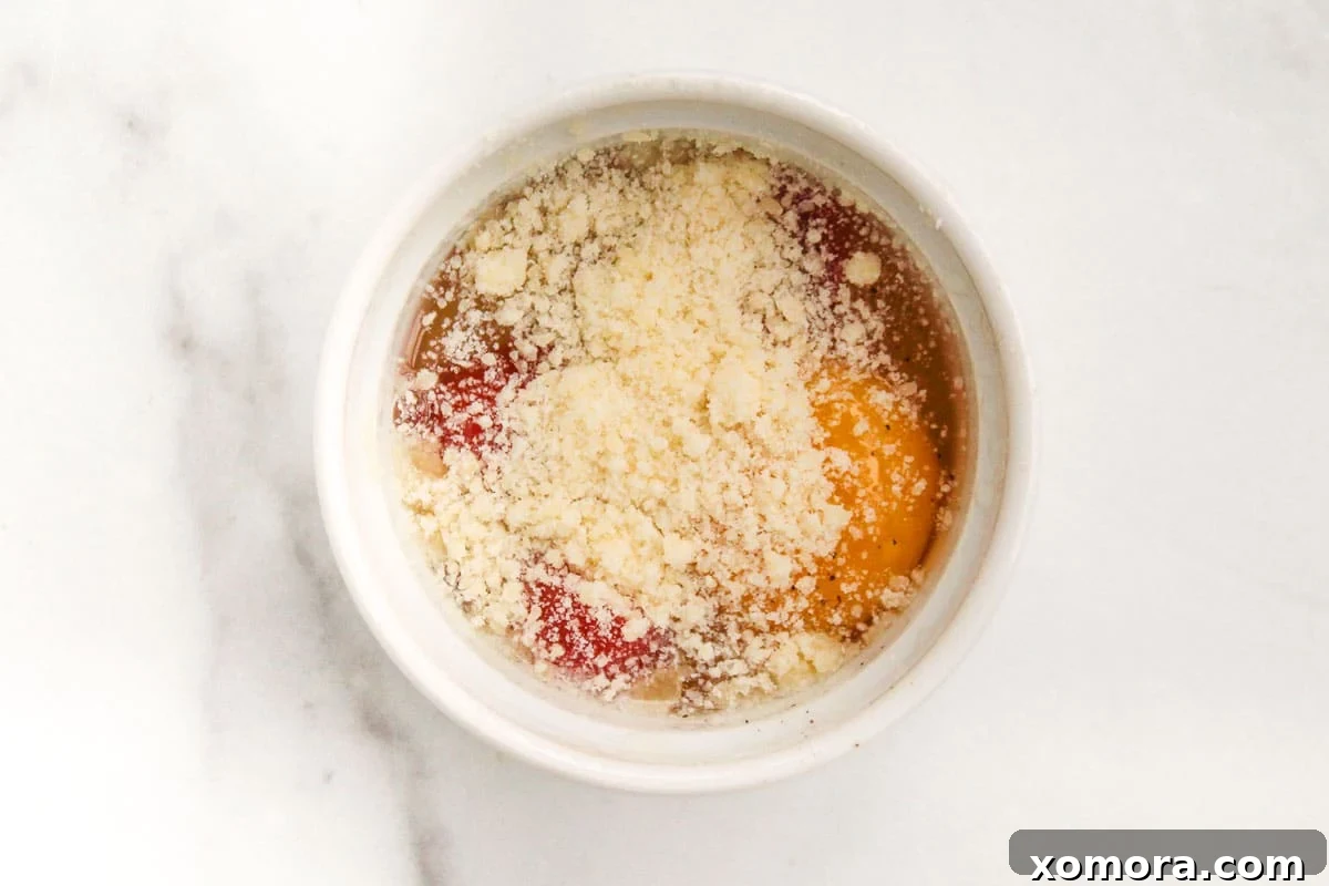 Three baked eggs in ramekins, close-up, featuring golden yolks and melted cheese, ready to be served.
