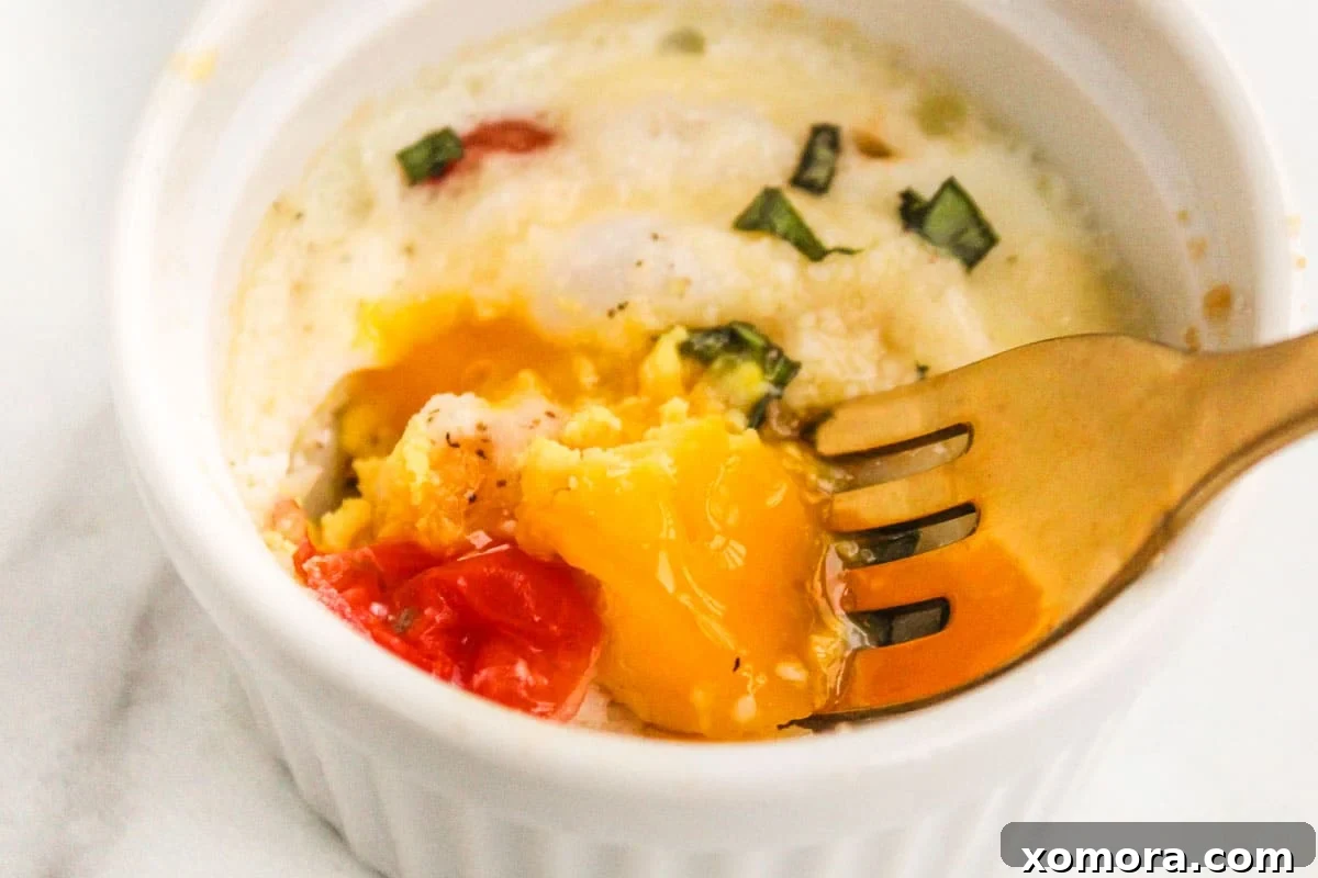 Baked eggs in ramekins with various appealing toppings, including fresh herbs, crumbled cheese, and crispy bacon bits.