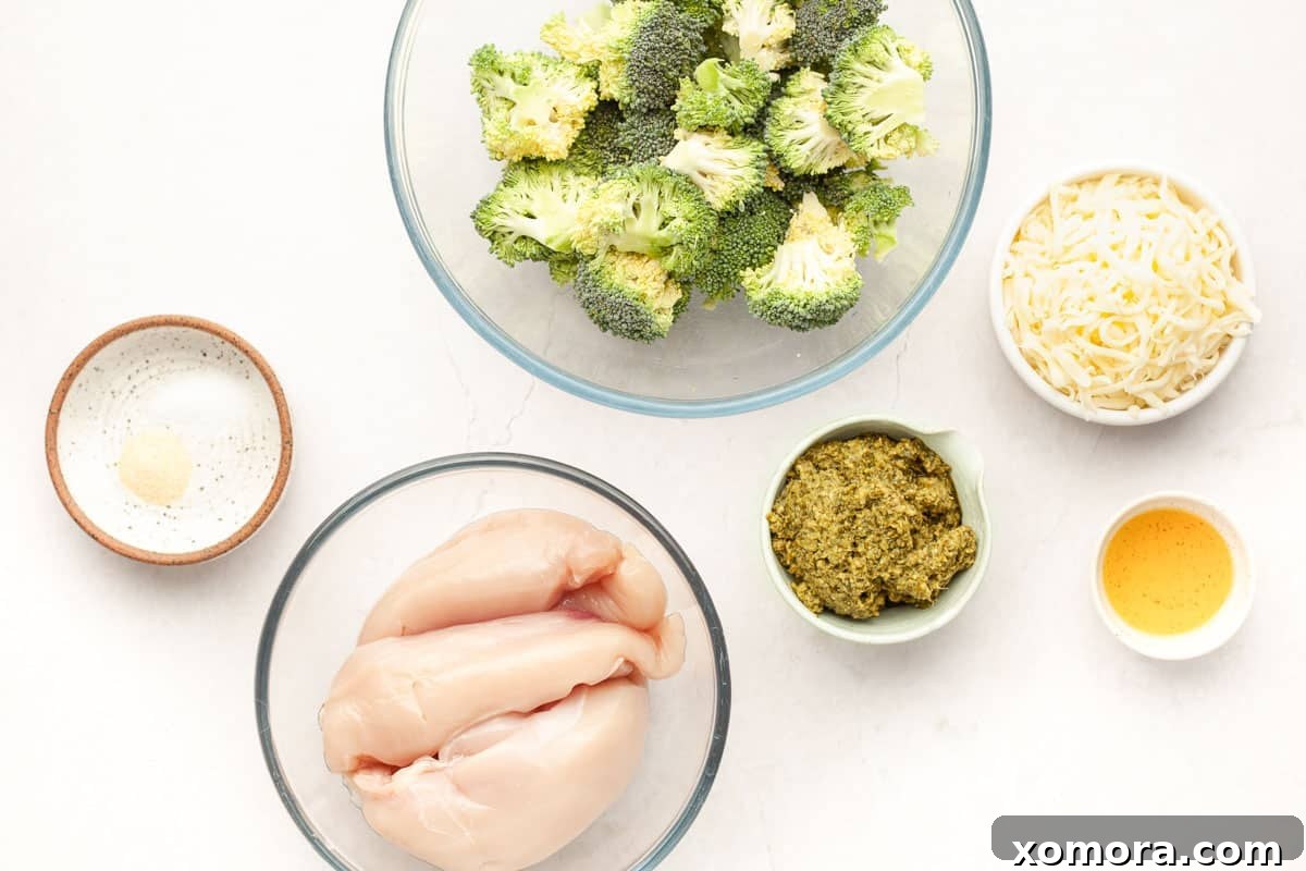 Fresh ingredients laid out for sheet pan pesto chicken with broccoli