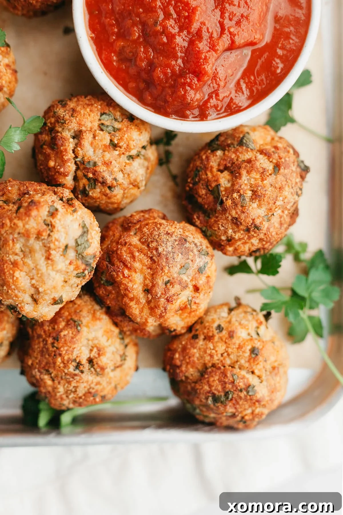 Savory Baked Parmesan Chicken Meatballs 2 Close-up of baked parmesan chicken meatballs on a plate