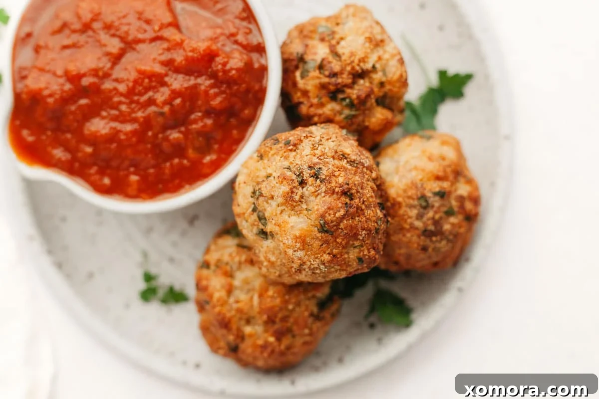 Savory Baked Parmesan Chicken Meatballs 6 Plate of baked parmesan chicken meatballs with pasta and sauce