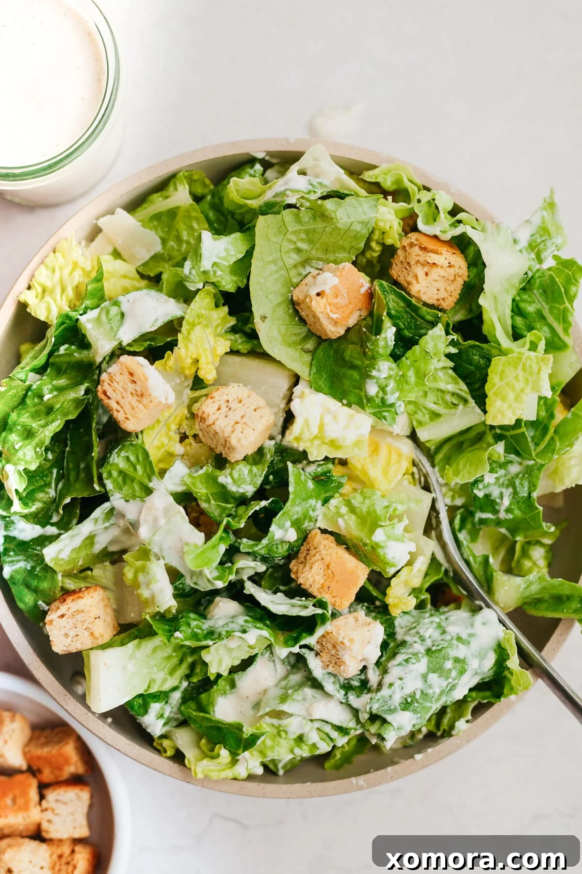 Quick Healthy Caesar Dressing Anchovy-Free 2 A bowl of creamy, homemade healthy Caesar salad dressing ready to be served.