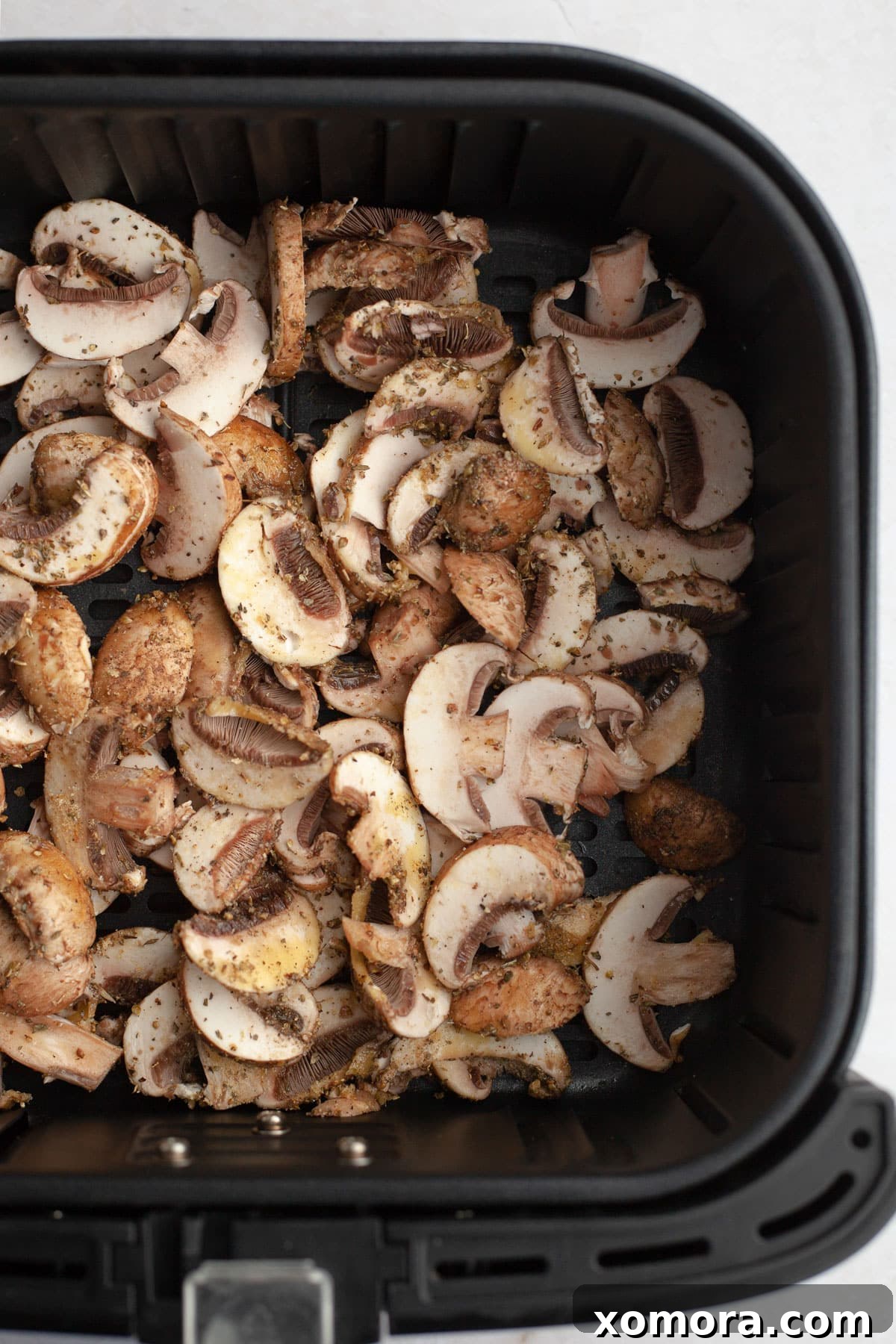 Simple Air Fryer Mushroom Perfection 4 Air fryer sliced mushrooms tossed with fresh herbs, ready to be served as a side dish
