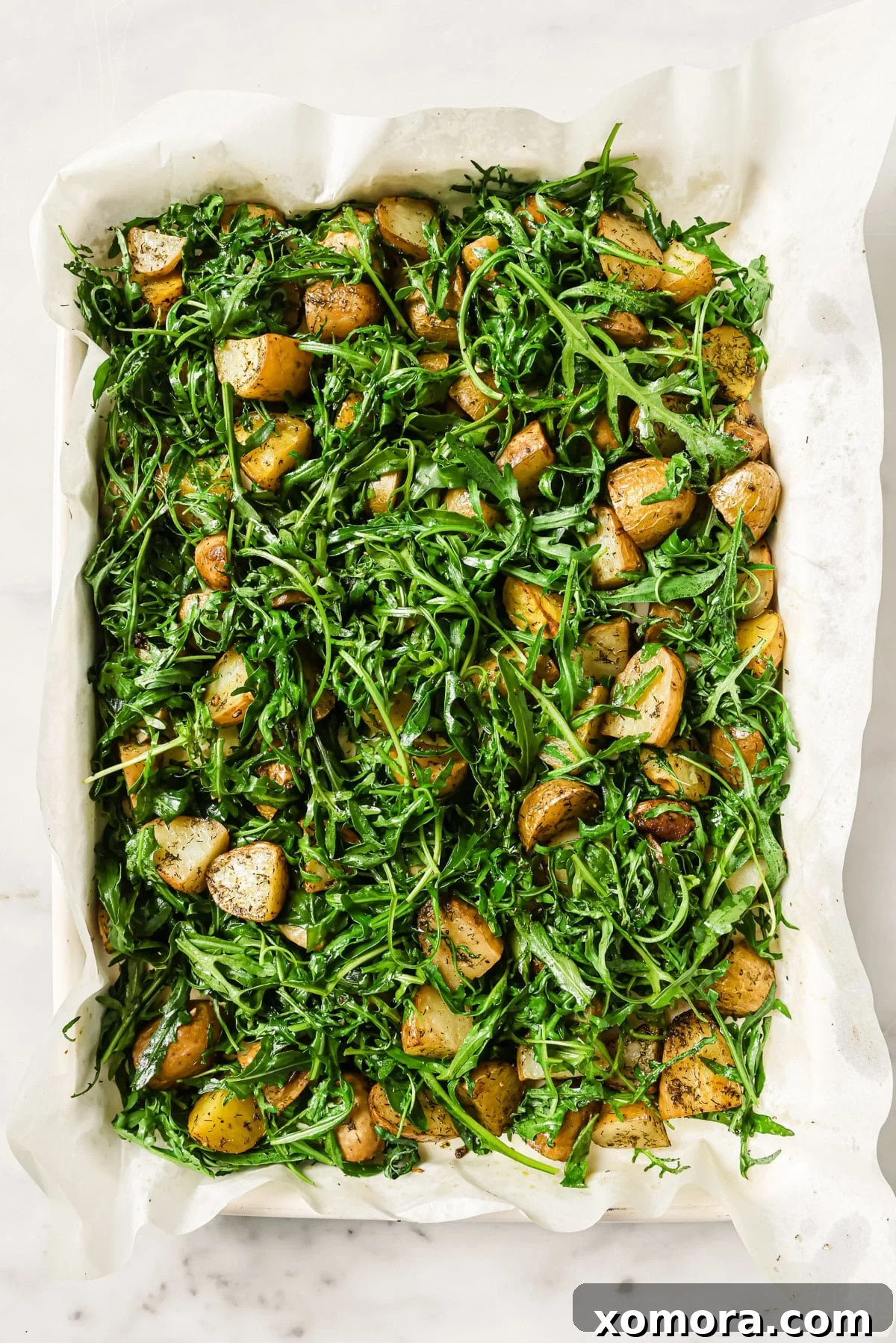 Ingredients laid out before cooking, including baby potatoes, arugula, feta, and lemon