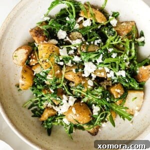 A close-up of the finished Warm Roasted Potato and Arugula Salad