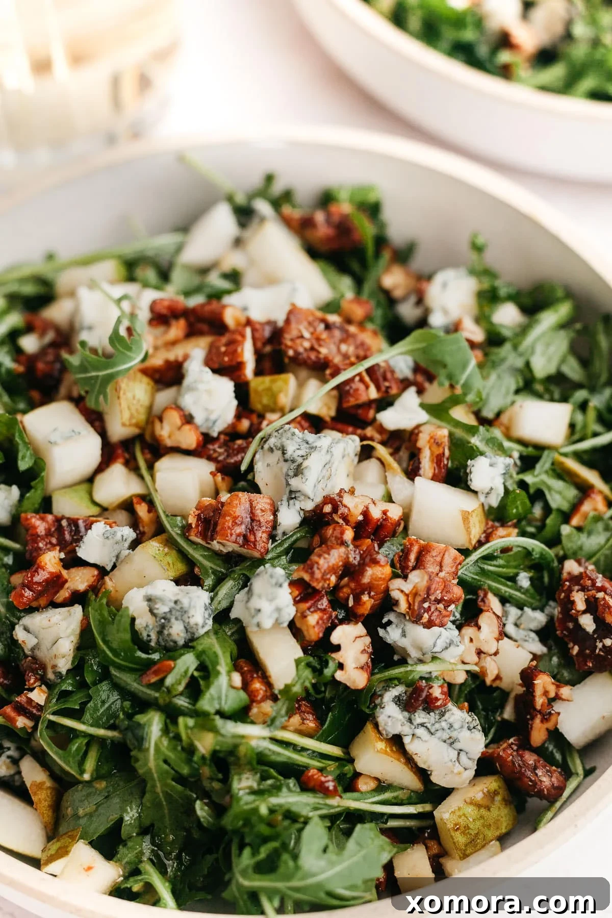 Crisp Pear Arugula Salad with Sweet Candied Pecans 2 A vibrant Arugula Pear Salad with Candied Pecans and Gorgonzola, beautifully arranged in a bowl.