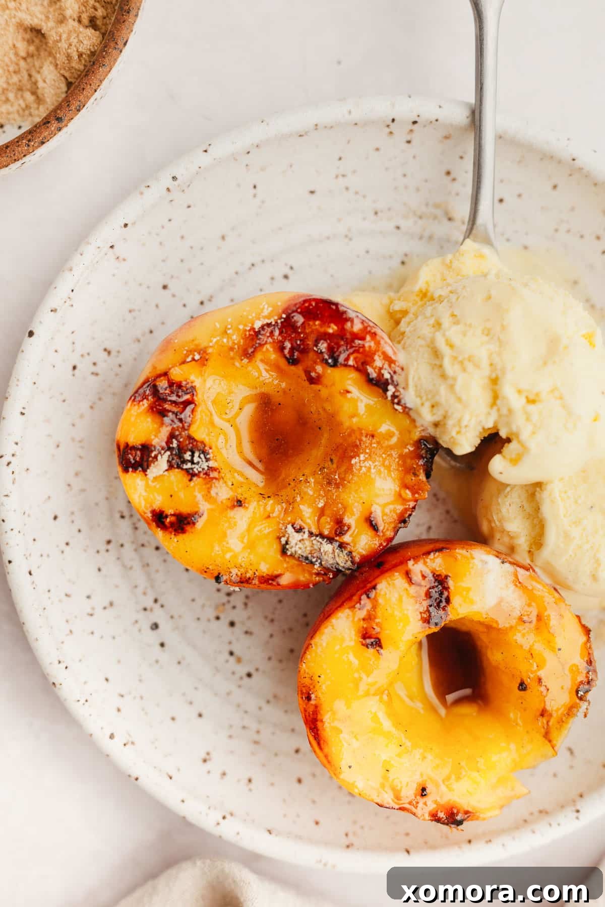 Caramelized Grilled Peaches with Creamy Vanilla 2 Delicious Grilled Peaches with Vanilla Ice Cream, overhead shot
