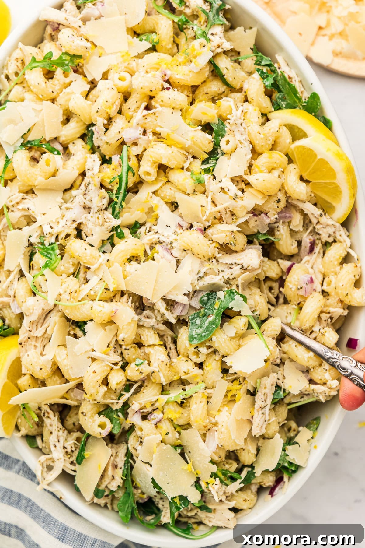 Sunshine Lemon Pasta Bowl 2 Close-up of creamy lemon pasta salad with shredded chicken, arugula, and red onion