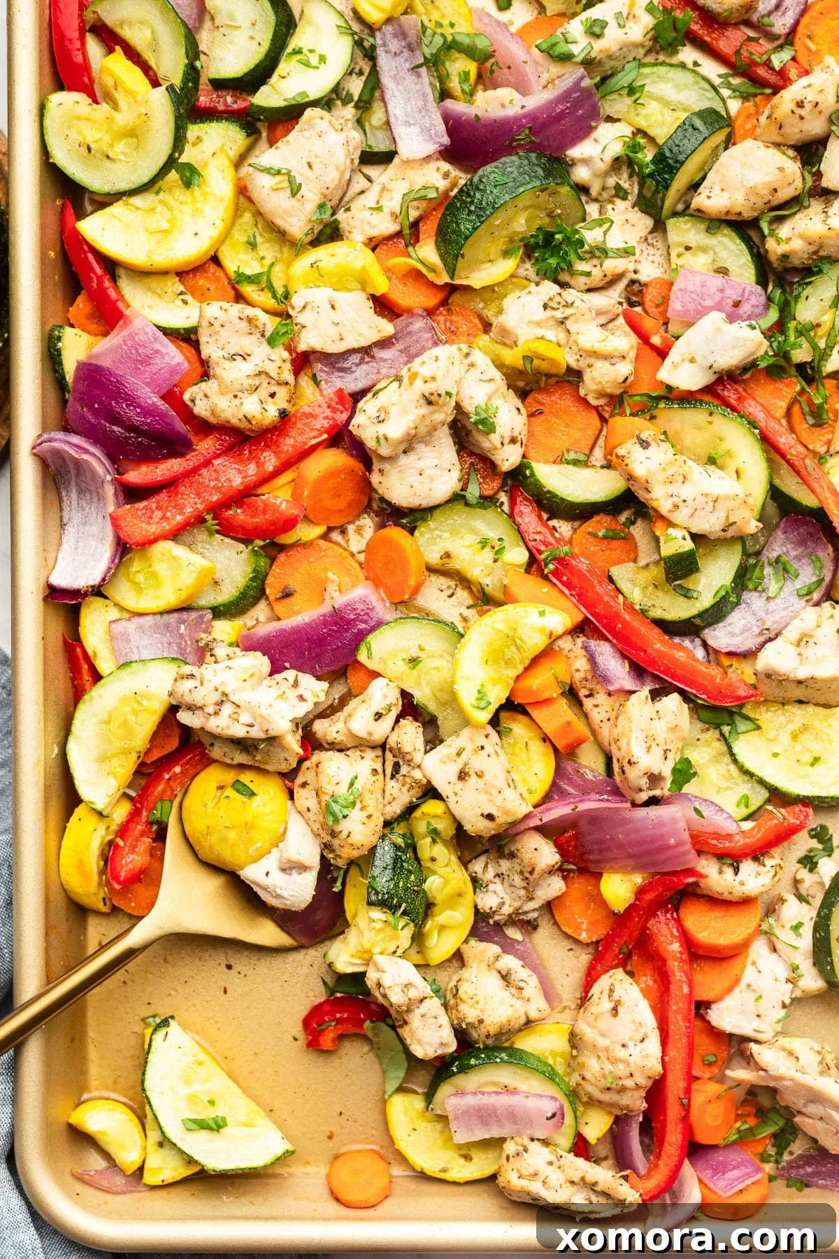 Sheet Pan Chicken and Rainbow Vegetables on a baking sheet, ready for roasting.