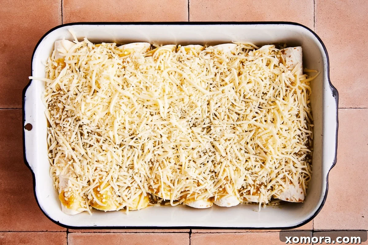 Effortless Green Chile Chicken Enchiladas 4 Ingredients for salsa verde chicken enchiladas, including shredded chicken, salsa verde, cream cheese, tortillas, and cheese.