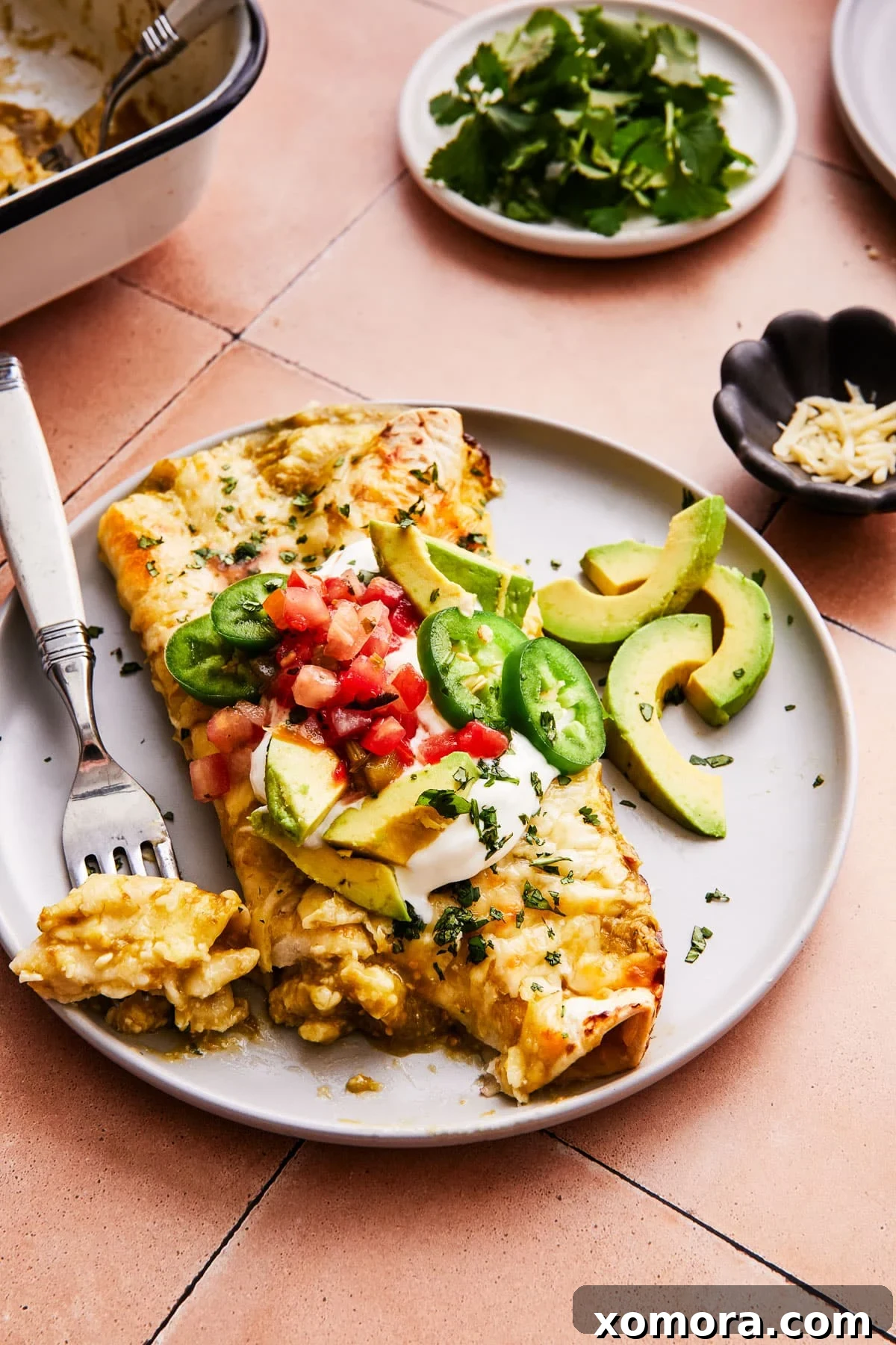 Effortless Green Chile Chicken Enchiladas 7 A vibrant platter of salsa verde chicken enchiladas, ready to be served, garnished with fresh toppings.