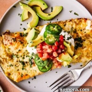Effortless Green Chile Chicken Enchiladas 8 A top-down view of a round bowl filled with salsa verde chicken enchiladas, garnished with fresh cilantro, a perfect presentation.