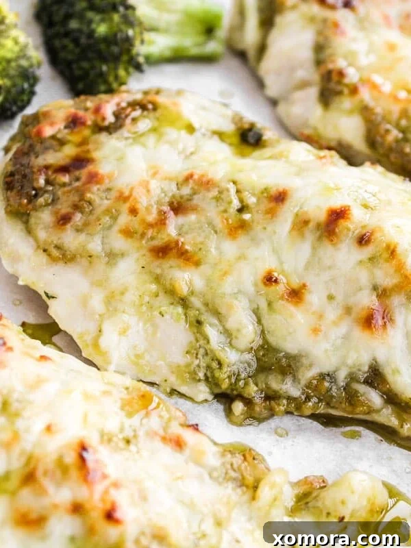 Sheet Pan Pesto Chicken with Broccoli, topped with melted mozzarella.